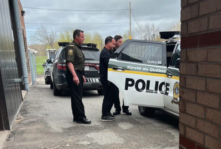 Grenier escorted to the courthouse by police