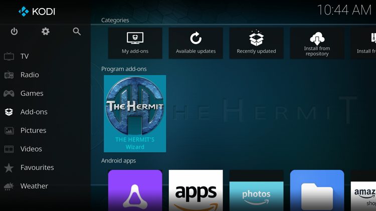 Return back to the home screen of Kodi, hover over Add-ons and click The Hermit's Wizard under Program add-ons.